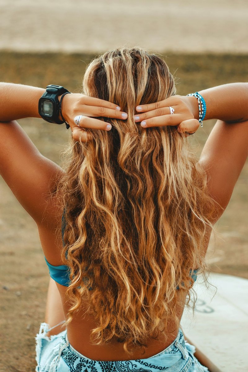 Rear view of long wavy hair outdoors.